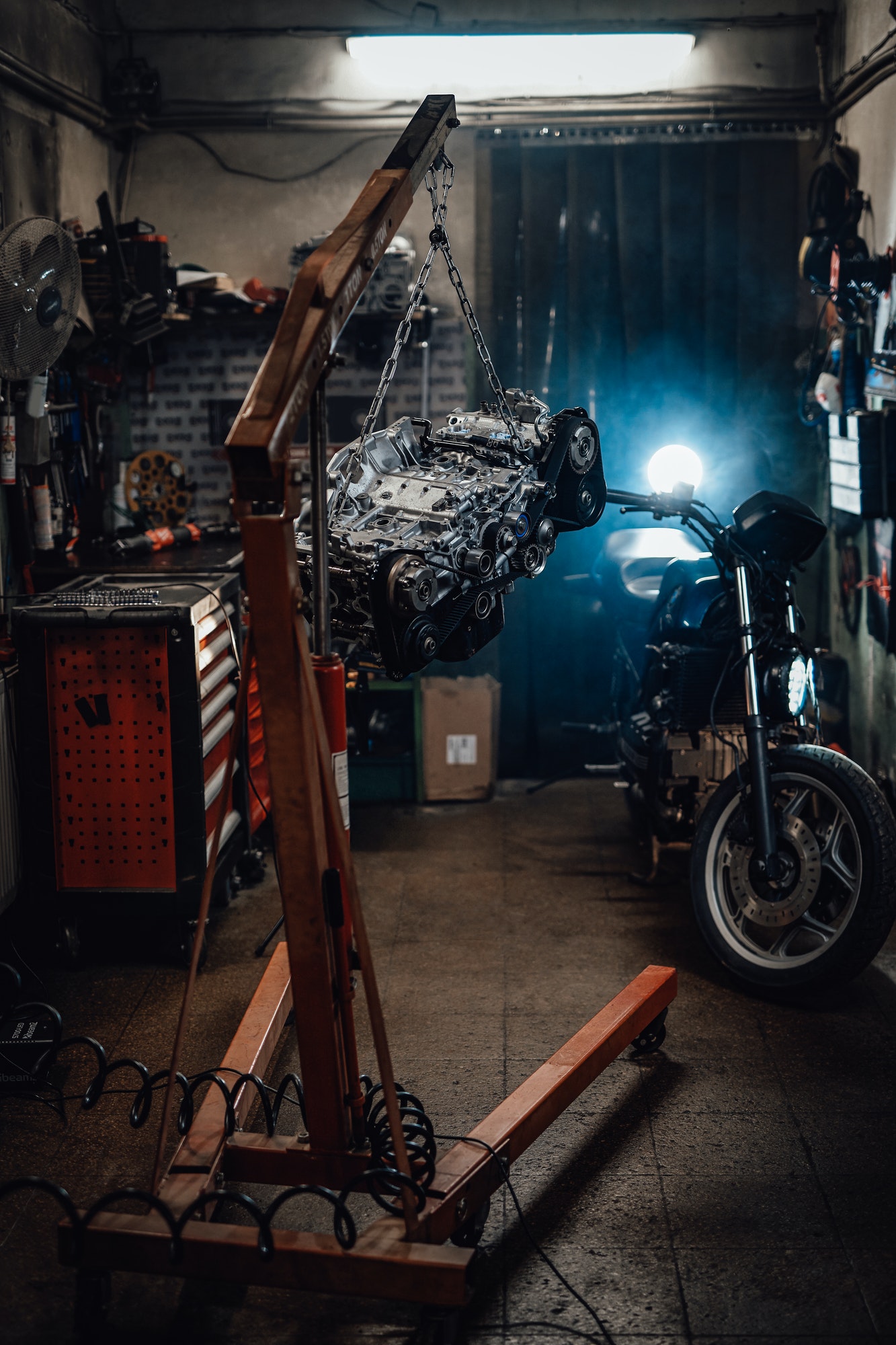 Suspended boxer engine, naked sportbike in dark garage or workshop